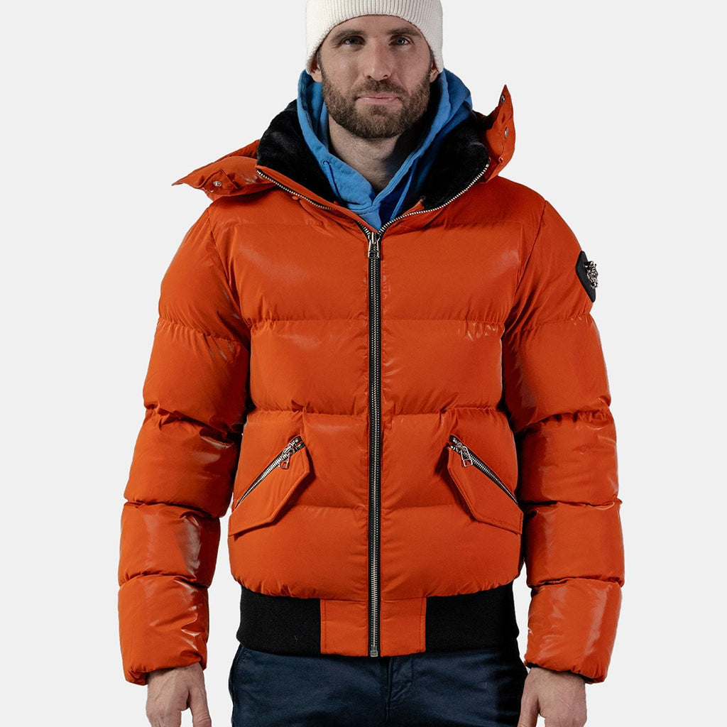 Woodpecker Men's Woody Bomber Winter coat. High-end Canadian designer winter coat for men in "All Wet Orange" colour. Woodpecker cruelty-free winter coat designed in Canada. Men's heavy weight short length premium designer jacket for winter. Superior quality warm winter coat for men. Moose Knuckles, Canada Goose, Mackage, Montcler, Will Poho, Willbird, Nic Bayley. Shiny parka. Stylish winter jacket. Designer winter coat.