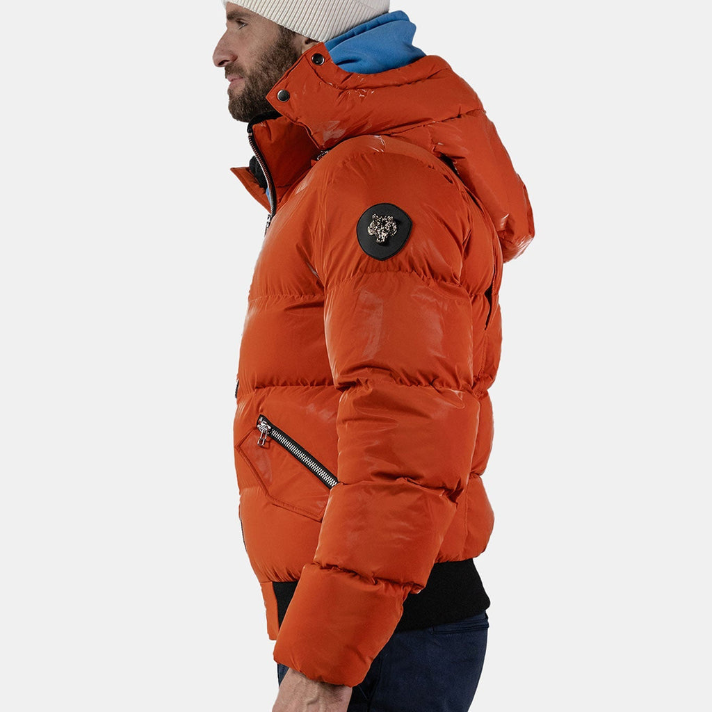 Woodpecker Men's Woody Bomber Winter coat. High-end Canadian designer winter coat for men in "All Wet Orange" colour. Woodpecker cruelty-free winter coat designed in Canada. Men's heavy weight short length premium designer jacket for winter. Superior quality warm winter coat for men. Moose Knuckles, Canada Goose, Mackage, Montcler, Will Poho, Willbird, Nic Bayley. Shiny parka. Stylish winter jacket. Designer winter coat.
