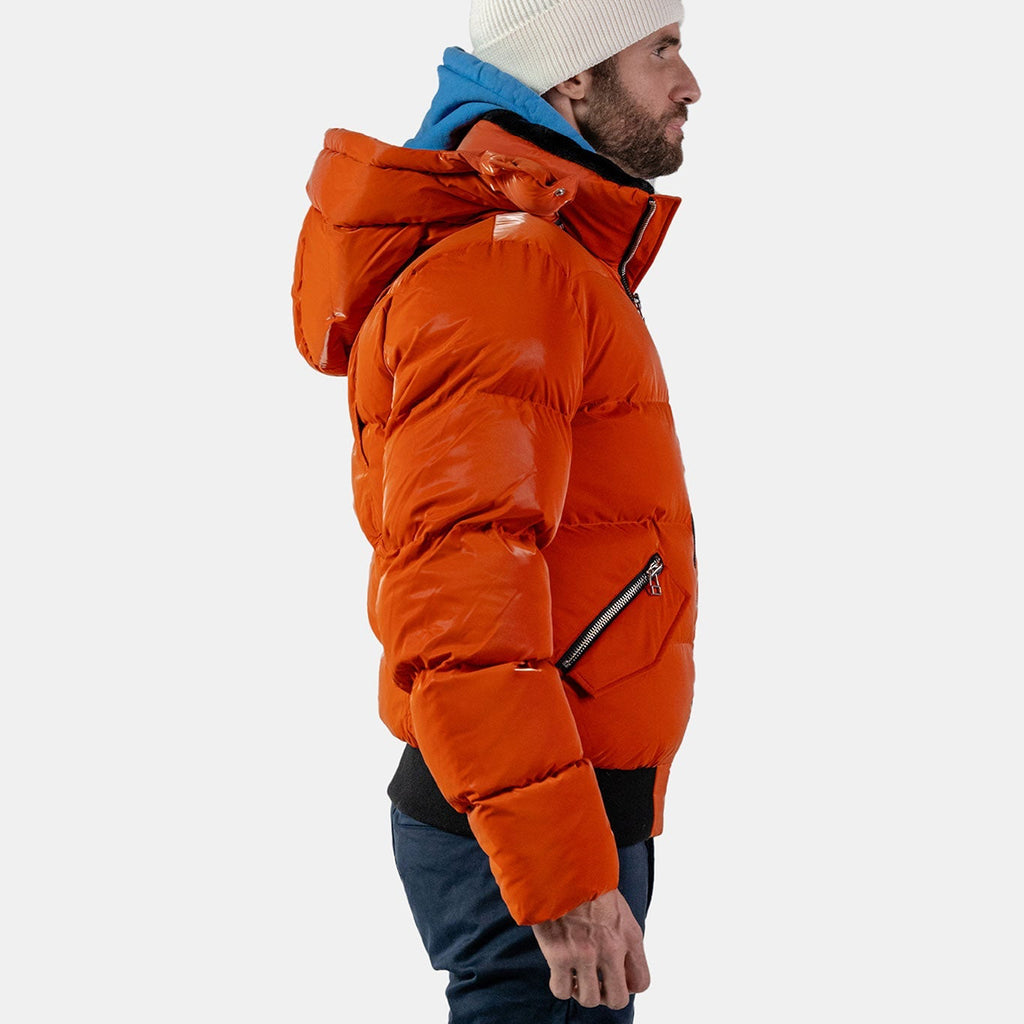 Woodpecker Men's Woody Bomber Winter coat. High-end Canadian designer winter coat for men in "All Wet Orange" colour. Woodpecker cruelty-free winter coat designed in Canada. Men's heavy weight short length premium designer jacket for winter. Superior quality warm winter coat for men. Moose Knuckles, Canada Goose, Mackage, Montcler, Will Poho, Willbird, Nic Bayley. Shiny parka. Stylish winter jacket. Designer winter coat.