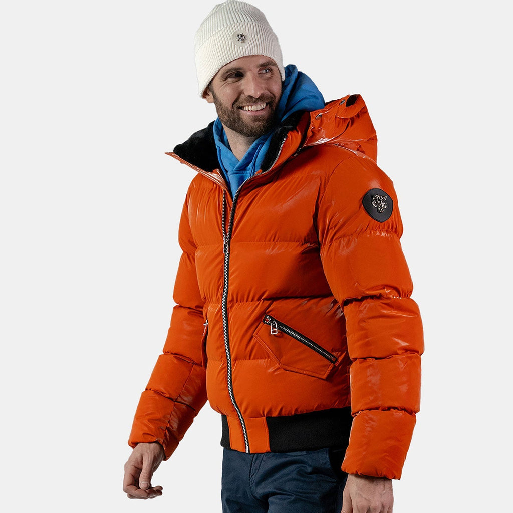 Woodpecker Men's Woody Bomber Winter coat. High-end Canadian designer winter coat for men in "All Wet Orange" colour. Woodpecker cruelty-free winter coat designed in Canada. Men's heavy weight short length premium designer jacket for winter. Superior quality warm winter coat for men. Moose Knuckles, Canada Goose, Mackage, Montcler, Will Poho, Willbird, Nic Bayley. Shiny parka. Stylish winter jacket. Designer winter coat.