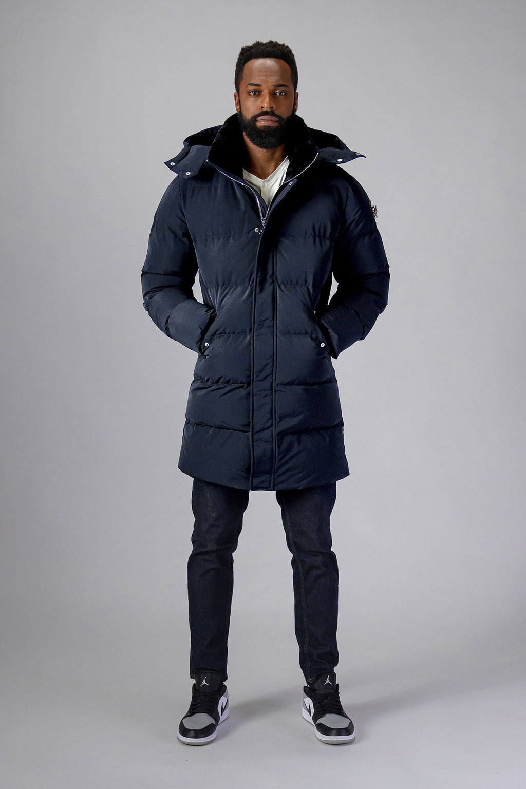 Woodpecker Men's Penguin Long Winter coat. High-end Canadian designer winter coat for men in "Blue Diamond" colour. Woodpecker cruelty-free winter coat designed in Canada. Men's heavy weight long length premium designer jacket for winter. Superior quality warm winter coat for men. Moose Knuckles, Canada Goose, Mackage, Montcler, Will Poho, Willbird, Nic Bayley. Extra warm. Shiny parka. Stylish winter jacket. Designer winter coat.