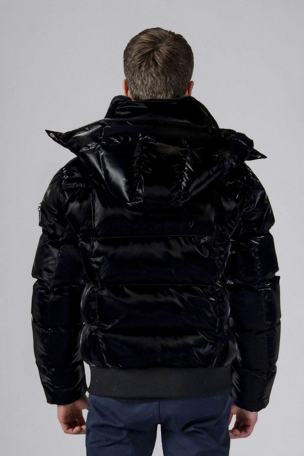 Woodpecker Men's Woody Bomber Winter coat. High-end Canadian designer winter coat for men in shiny “All Wet Black" colour. Woodpecker cruelty-free winter coat designed in Canada. Men's heavy weight short length premium designer jacket for winter. Superior quality warm winter coat for men. Moose Knuckles, Canada Goose, Mackage, Montcler, Will Poho, Willbird, Nic Bayley. Shiny parka. Stylish winter jacket. Designer winter coat.