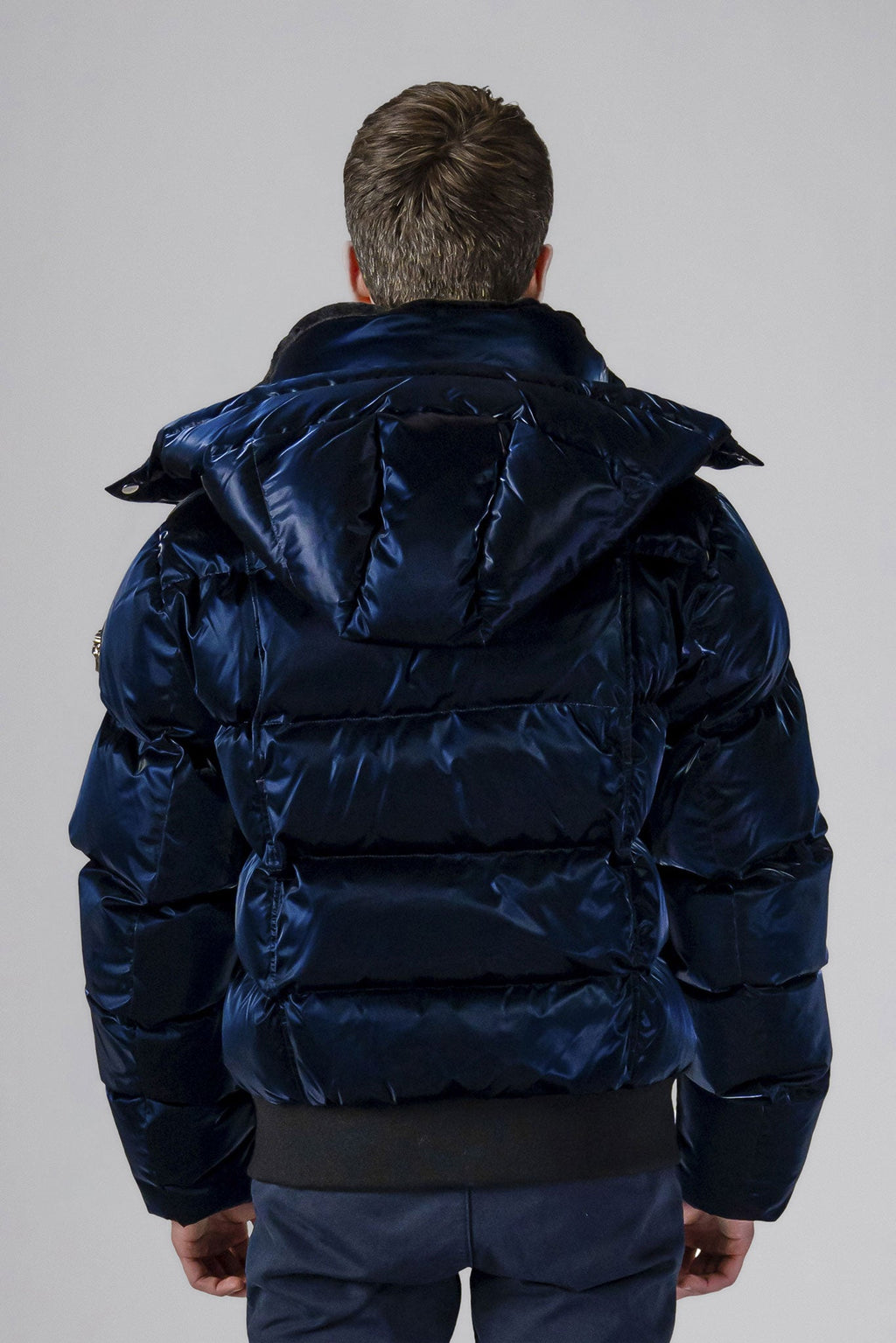 Woodpecker Men's Woody Bomber Winter coat. High-end Canadian designer winter coat for men in shiny “All Wet Navy" colour. Woodpecker cruelty-free winter coat designed in Canada. Men's heavy weight short length premium designer jacket for winter. Superior quality warm winter coat for men. Moose Knuckles, Canada Goose, Mackage, Montcler, Will Poho, Willbird, Nic Bayley. Shiny parka. Stylish winter jacket. Designer winter coat.