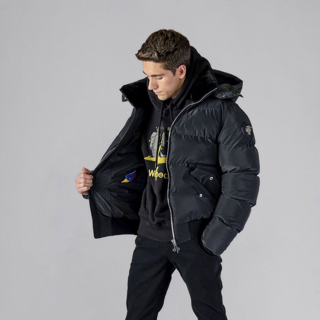 Woodpecker Men's Woody Bomber Winter coat. High-end Canadian designer winter coat for men in "Black Diamond" colour. Woodpecker cruelty-free winter coat designed in Canada. Men's heavy weight short length premium designer jacket for winter. Superior quality warm winter coat for men. Moose Knuckles, Canada Goose, Mackage, Montcler, Will Poho, Willbird, Nic Bayley. Shiny parka. Stylish winter jacket. Designer winter coat.