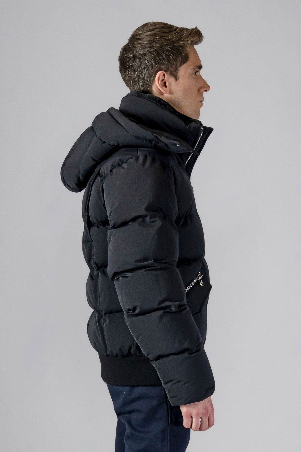 Woodpecker Men's Woody Bomber Winter coat. High-end Canadian designer winter coat for men in “Matte Black" colour. Woodpecker cruelty-free winter coat designed in Canada. Men's heavy weight short length premium designer jacket for winter. Superior quality warm winter coat for men. Moose Knuckles, Canada Goose, Mackage, Montcler, Will Poho, Willbird, Nic Bayley. Shiny parka. Stylish winter jacket. Designer winter coat.