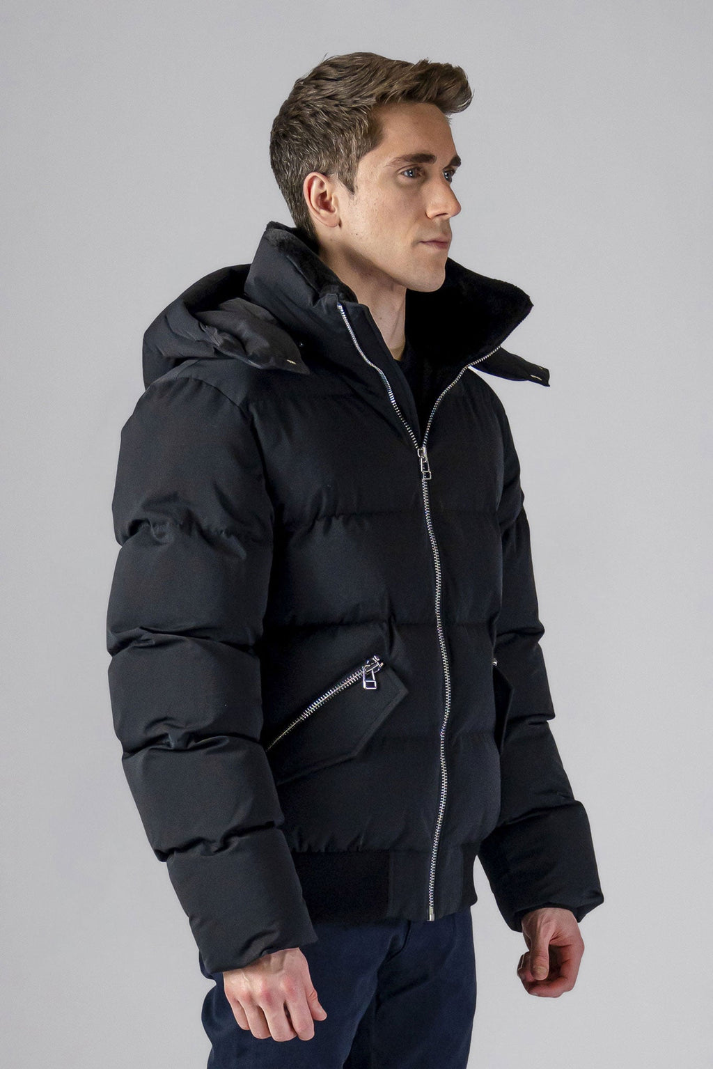 Woodpecker Men's Woody Bomber Winter coat. High-end Canadian designer winter coat for men in “Matte Black" colour. Woodpecker cruelty-free winter coat designed in Canada. Men's heavy weight short length premium designer jacket for winter. Superior quality warm winter coat for men. Moose Knuckles, Canada Goose, Mackage, Montcler, Will Poho, Willbird, Nic Bayley. Shiny parka. Stylish winter jacket. Designer winter coat.