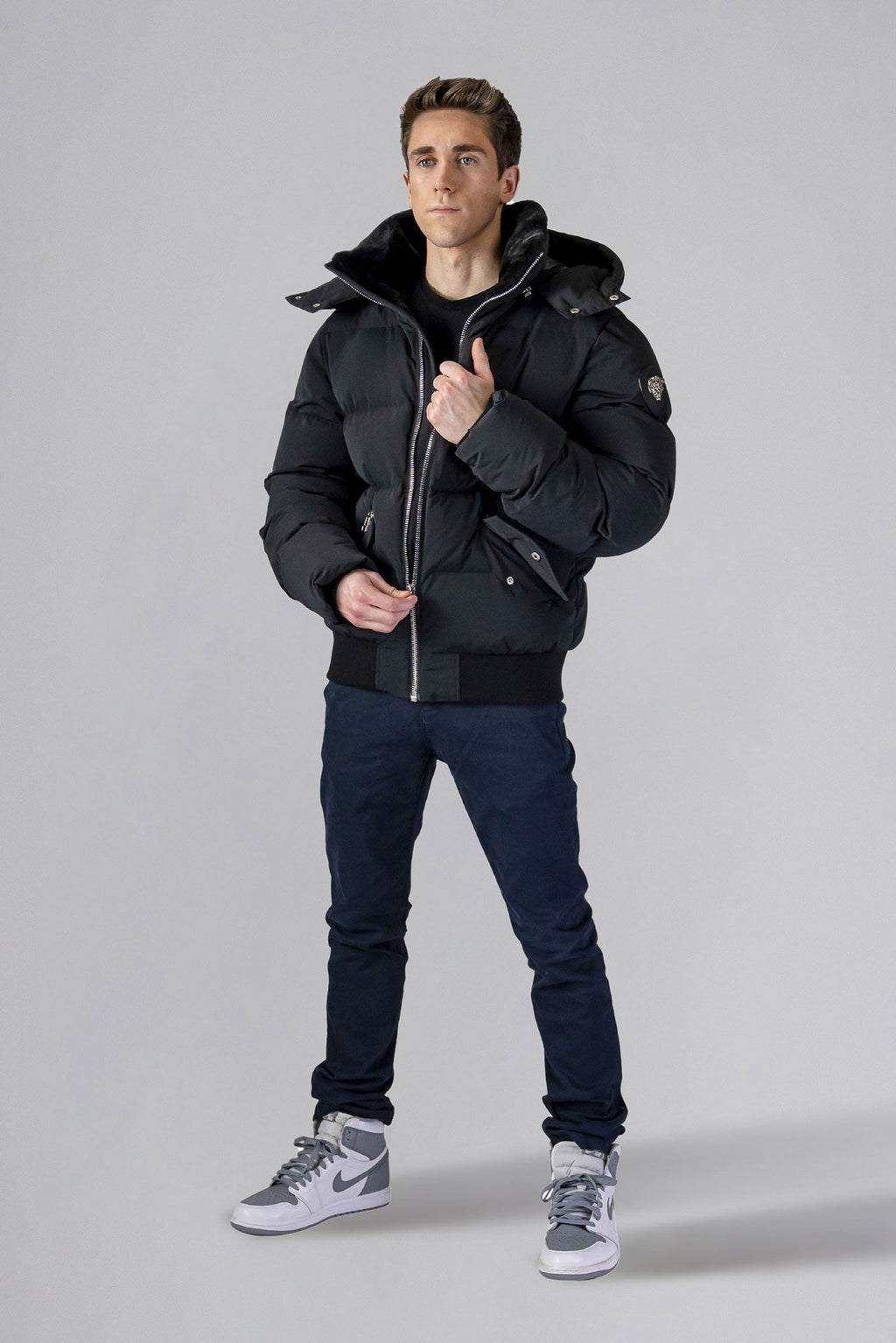 Woodpecker Men's Woody Bomber Winter coat. High-end Canadian designer winter coat for men in “Matte Black" colour. Woodpecker cruelty-free winter coat designed in Canada. Men's heavy weight short length premium designer jacket for winter. Superior quality warm winter coat for men. Moose Knuckles, Canada Goose, Mackage, Montcler, Will Poho, Willbird, Nic Bayley. Shiny parka. Stylish winter jacket. Designer winter coat.