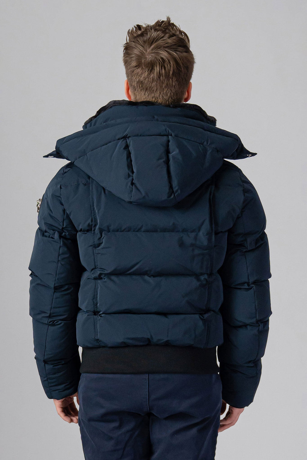 Woodpecker Men's Woody Bomber Winter coat. High-end Canadian designer winter coat for men in “Matte Navy" colour. Woodpecker cruelty-free winter coat designed in Canada. Men's heavy weight short length premium designer jacket for winter. Superior quality warm winter coat for men. Moose Knuckles, Canada Goose, Mackage, Montcler, Will Poho, Willbird, Nic Bayley. Shiny parka. Stylish winter jacket. Designer winter coat.