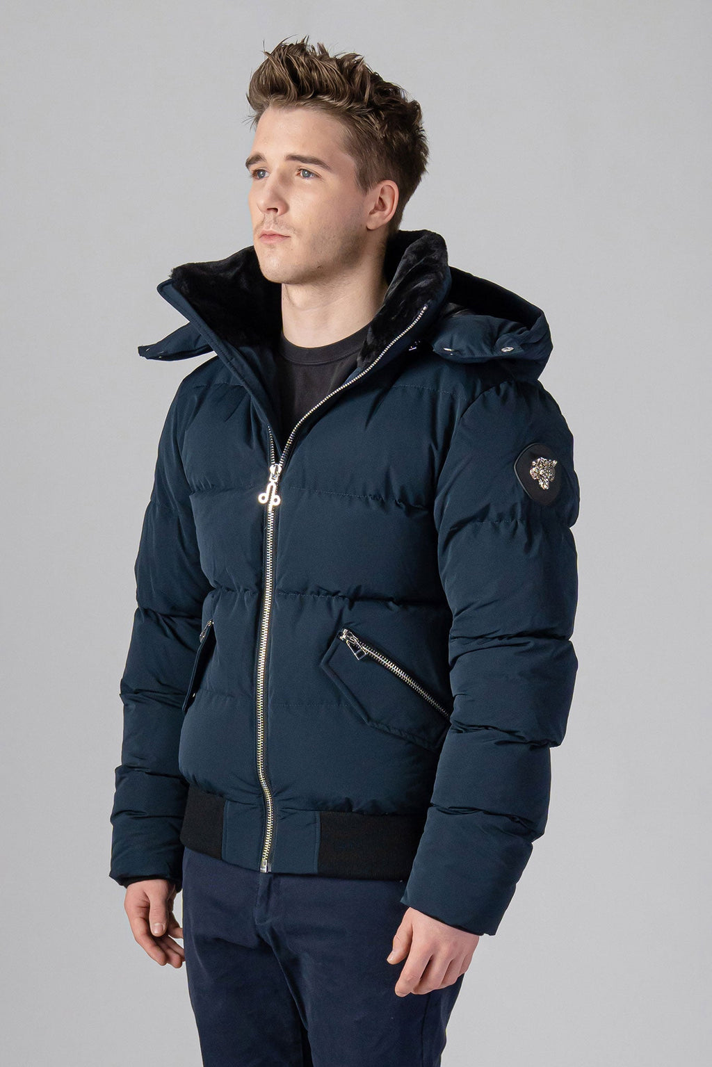 Woodpecker Men's Woody Bomber Winter coat. High-end Canadian designer winter coat for men in “Matte Navy" colour. Woodpecker cruelty-free winter coat designed in Canada. Men's heavy weight short length premium designer jacket for winter. Superior quality warm winter coat for men. Moose Knuckles, Canada Goose, Mackage, Montcler, Will Poho, Willbird, Nic Bayley. Shiny parka. Stylish winter jacket. Designer winter coat.