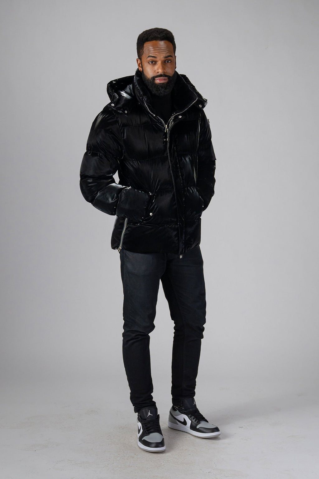 Woodpecker Men's Bumnester Winter coat. High-end Canadian designer winter coat for men in "All Wet Black" colour. Woodpecker cruelty-free winter coat designed in Canada. Men's heavy weight medium length premium designer jacket for winter. Superior quality warm winter coat for men. Moose Knuckles, Canada Goose, Mackage, Montcler, Will Poho, Willbird, Nic Bayley. Shiny parka. Stylish winter jacket. Designer winter coat.