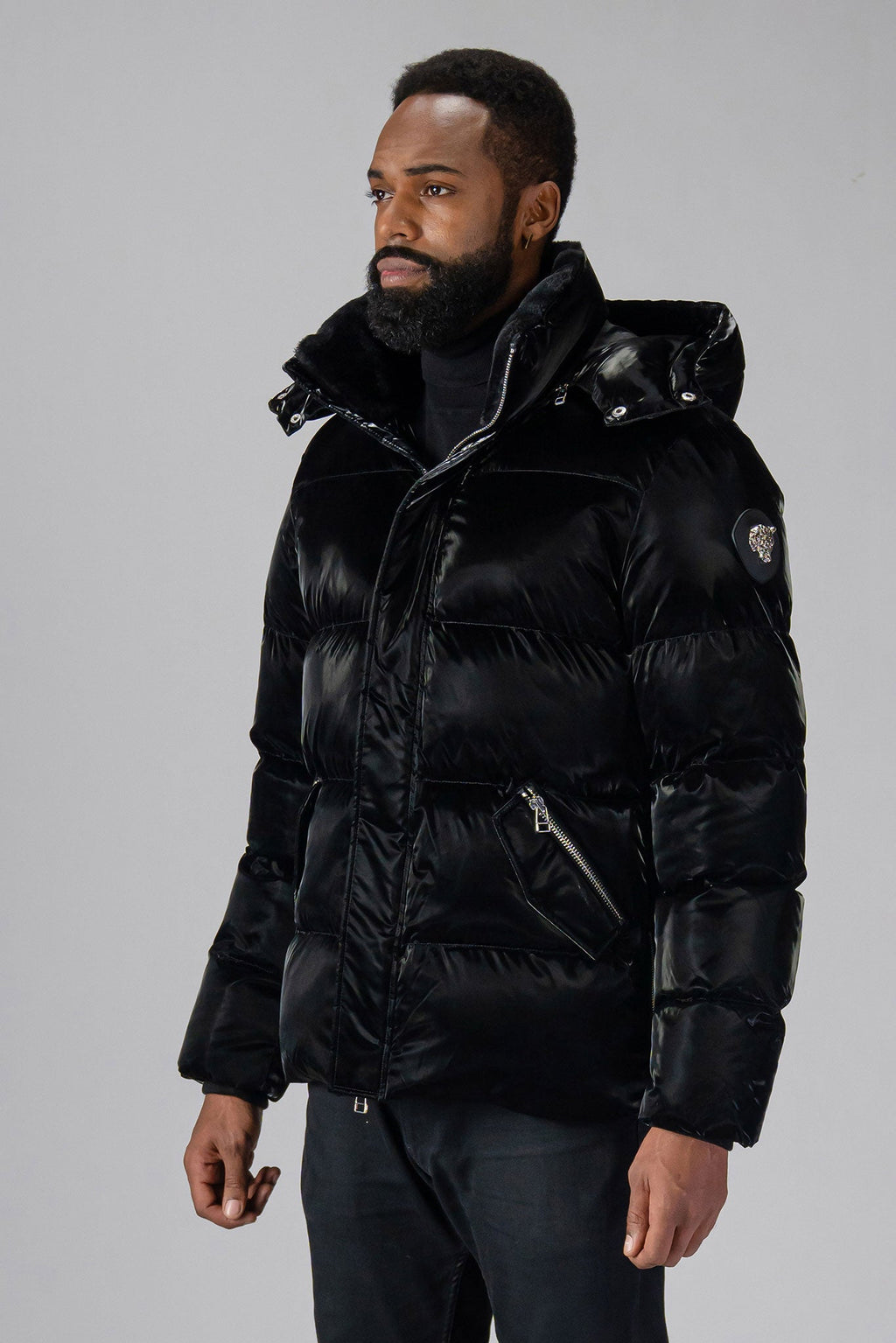 Woodpecker Men's Bumnester Winter coat. High-end Canadian designer winter coat for men in "All Wet Black" colour. Woodpecker cruelty-free winter coat designed in Canada. Men's heavy weight medium length premium designer jacket for winter. Superior quality warm winter coat for men. Moose Knuckles, Canada Goose, Mackage, Montcler, Will Poho, Willbird, Nic Bayley. Shiny parka. Stylish winter jacket. Designer winter coat.