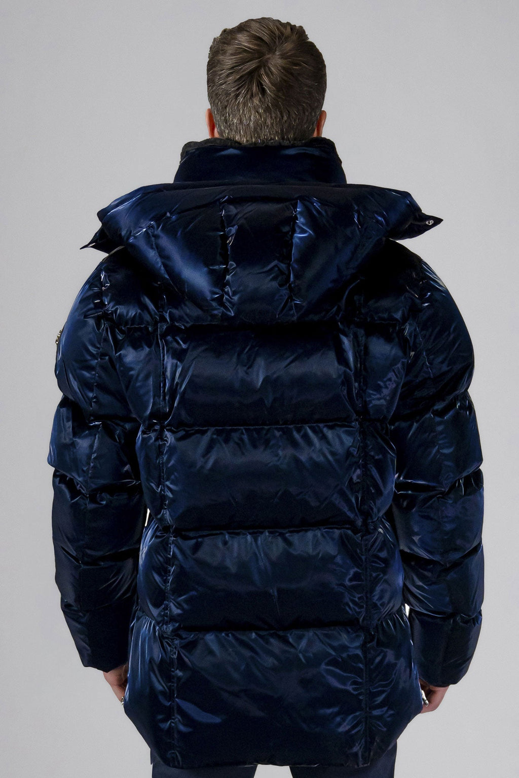 Woodpecker Men's Bumnester Winter coat. High-end Canadian designer winter coat for men in "All Wet Navy" colour. Woodpecker cruelty-free winter coat designed in Canada. Men's heavy weight medium length premium designer jacket for winter. Superior quality warm winter coat for men. Moose Knuckles, Canada Goose, Mackage, Montcler, Will Poho, Willbird, Nic Bayley. Shiny parka. Stylish winter jacket. Designer winter coat.
