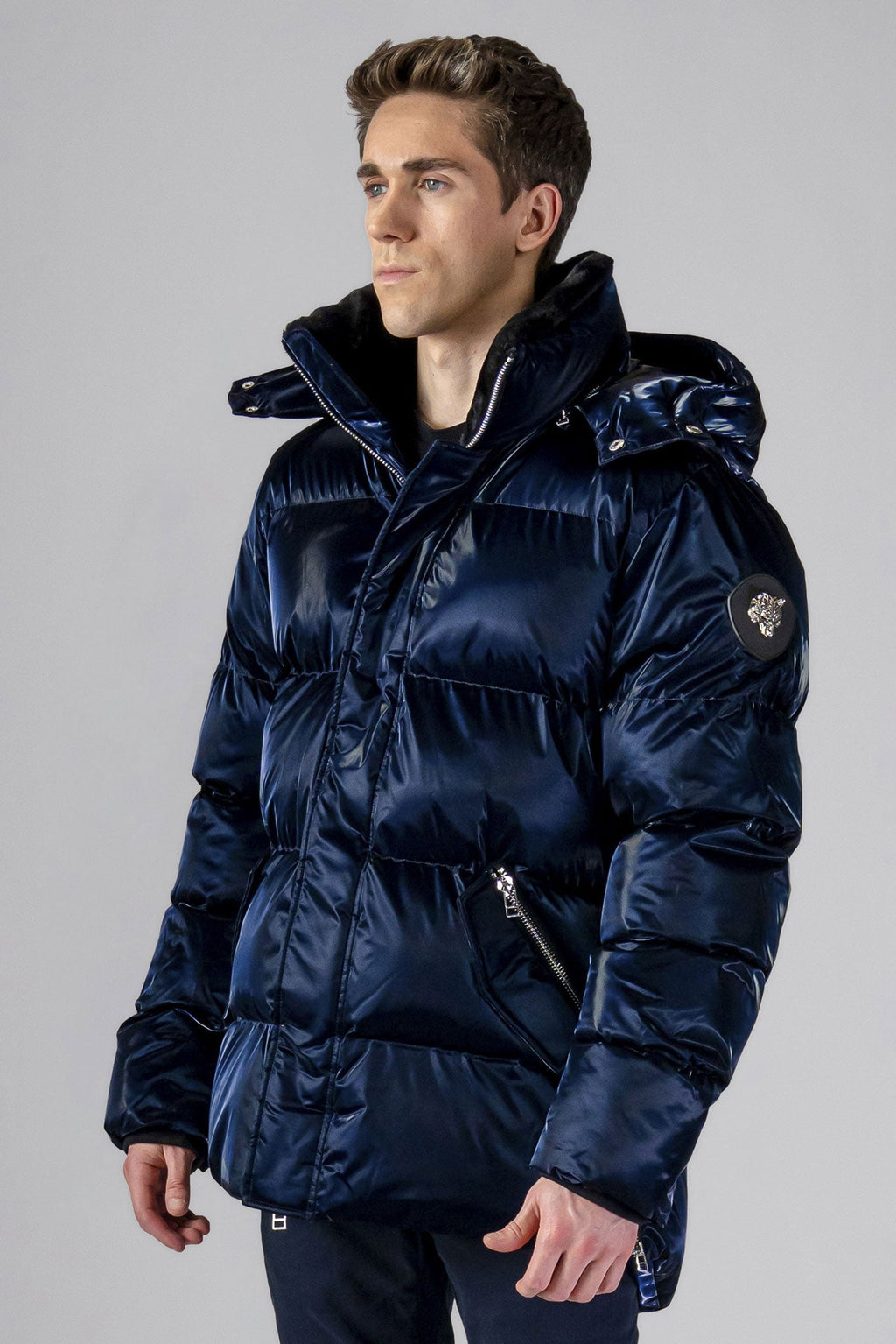 Woodpecker Men's Bumnester Winter coat. High-end Canadian designer winter coat for men in "All Wet Navy" colour. Woodpecker cruelty-free winter coat designed in Canada. Men's heavy weight medium length premium designer jacket for winter. Superior quality warm winter coat for men. Moose Knuckles, Canada Goose, Mackage, Montcler, Will Poho, Willbird, Nic Bayley. Shiny parka. Stylish winter jacket. Designer winter coat.