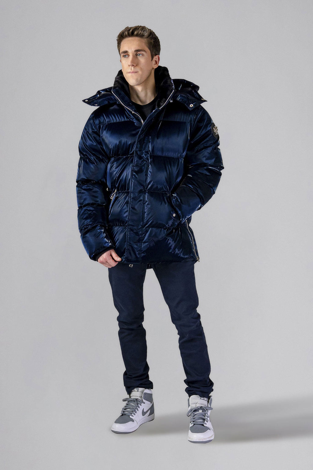 Woodpecker Men's Bumnester Winter coat. High-end Canadian designer winter coat for men in "All Wet Navy" colour. Woodpecker cruelty-free winter coat designed in Canada. Men's heavy weight medium length premium designer jacket for winter. Superior quality warm winter coat for men. Moose Knuckles, Canada Goose, Mackage, Montcler, Will Poho, Willbird, Nic Bayley. Shiny parka. Stylish winter jacket. Designer winter coat.