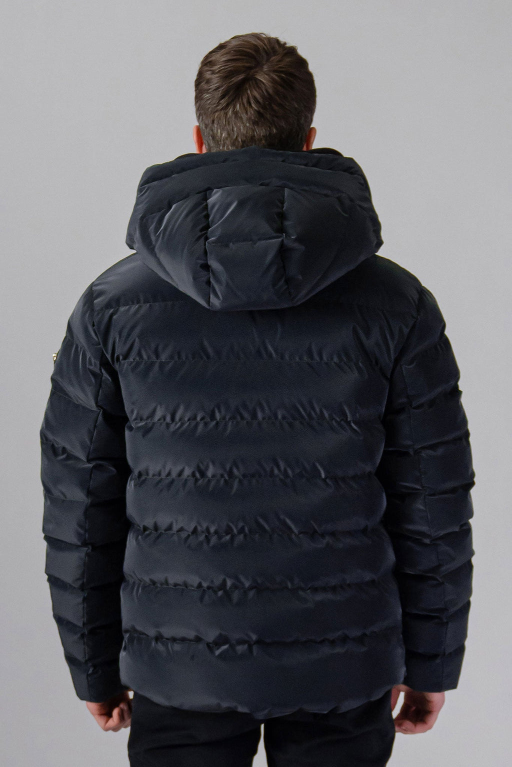 Woodpecker Men's Sparrow Winter coat. High-end Canadian designer winter coat for men in "Black Diamond" colour. Woodpecker cruelty-free winter coat designed in Canada. Men's medium weight medium length premium designer jacket for winter. Superior quality warm winter coat for men. Moose Knuckles, Canada Goose, Mackage, Montcler, Will Poho, Willbird, Nic Bayley. Shiny parka. Stylish winter jacket. Designer winter coat.