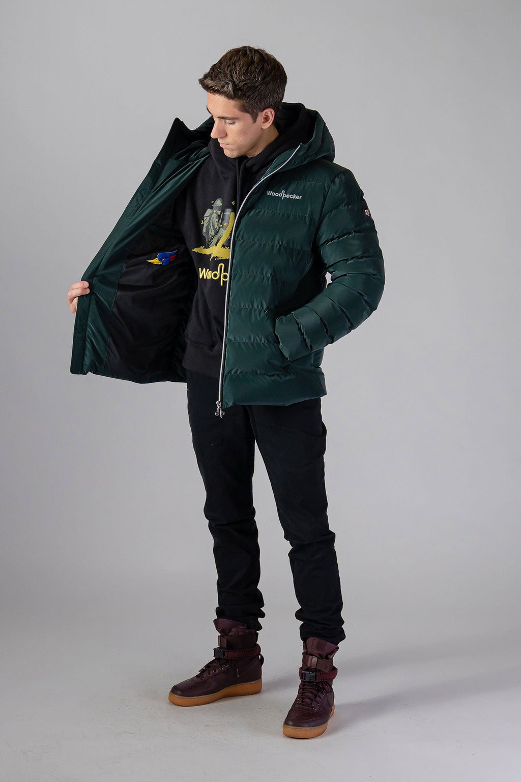 Woodpecker Men's Sparrow Winter coat. High-end Canadian designer winter coat for men in "Green Diamond" colour. Woodpecker cruelty-free winter coat designed in Canada. Men's medium weight medium length premium designer jacket for winter. Superior quality warm winter coat for men. Moose Knuckles, Canada Goose, Mackage, Montcler, Will Poho, Willbird, Nic Bayley. Shiny parka. Stylish winter jacket. Designer winter coat.