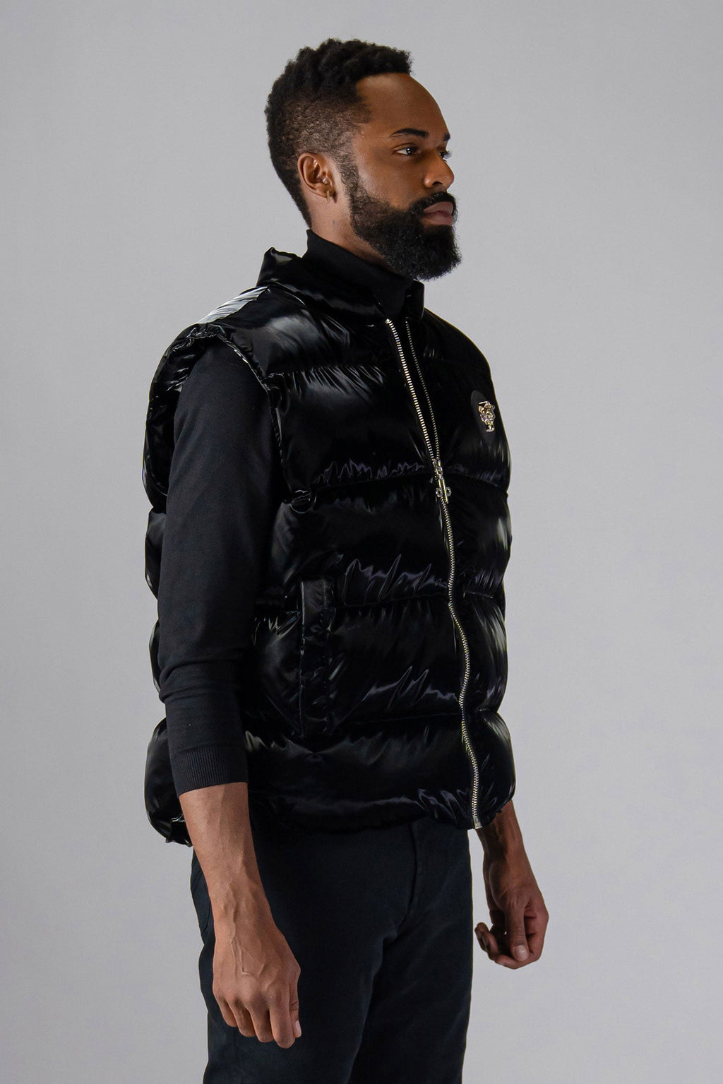 Woodpecker Unisex Winter Vest. High-end Canadian designer winter vest in "All Wet Black" colour. Woodpecker cruelty-free vest designed in Canada. Heavy weight short length premium designer vest for winter. Superior quality warm winter vest. Moose Knuckles, Canada Goose, Mackage, Montcler, Will Poho, Willbird, Nic Bayley. Extra warm. Shiny vest. Stylish winter vest. Designer winter vest.