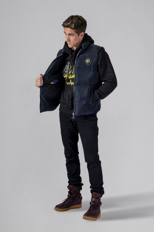 Woodpecker Unisex Winter Vest. High-end Canadian designer winter vest in "Blue Diamond" colour. Woodpecker cruelty-free vest designed in Canada. Heavy weight short length premium designer vest for winter. Superior quality warm winter vest. Moose Knuckles, Canada Goose, Mackage, Montcler, Will Poho, Willbird, Nic Bayley. Extra warm. Shiny vest. Stylish winter vest. Designer winter vest.