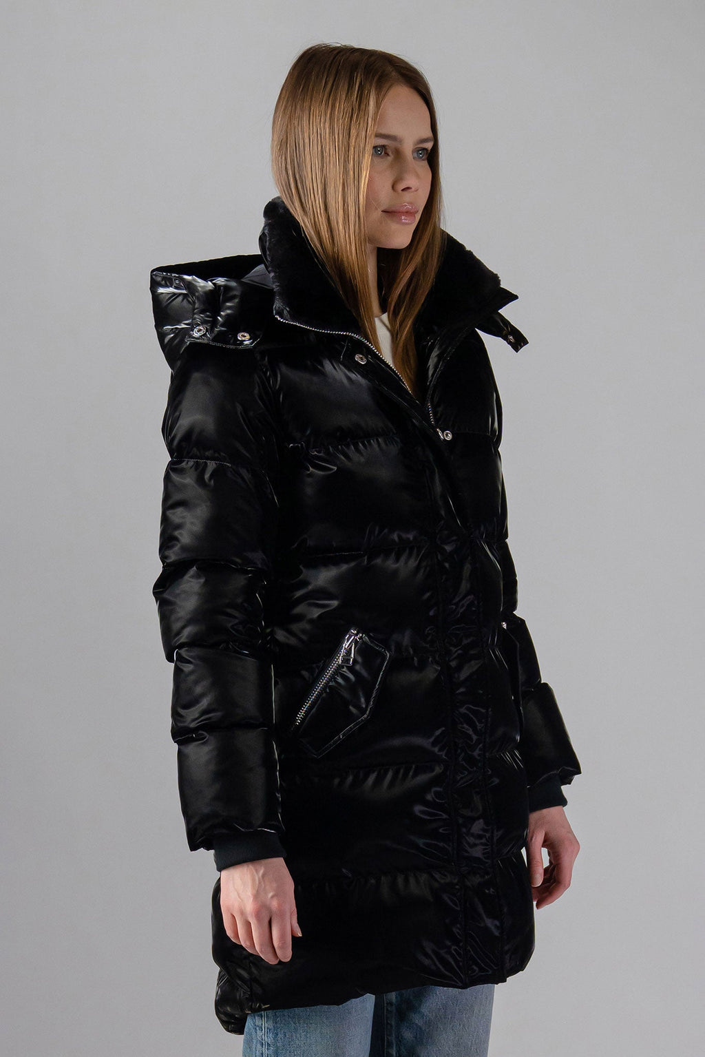 Woodpecker Women's Penguin Long Winter coat. High-end Canadian designer winter coat for women in "All Wet Black" colour. Woodpecker cruelty-free winter coat designed in Canada. Women's heavy weight long length premium designer jacket for winter. Superior quality warm winter coat for women. Moose Knuckles, Canada Goose, Mackage, Montcler, Will Poho, Willbird, Nic Bayley. Extra warm. Shiny parka. Stylish winter jacket. Designer winter coat.