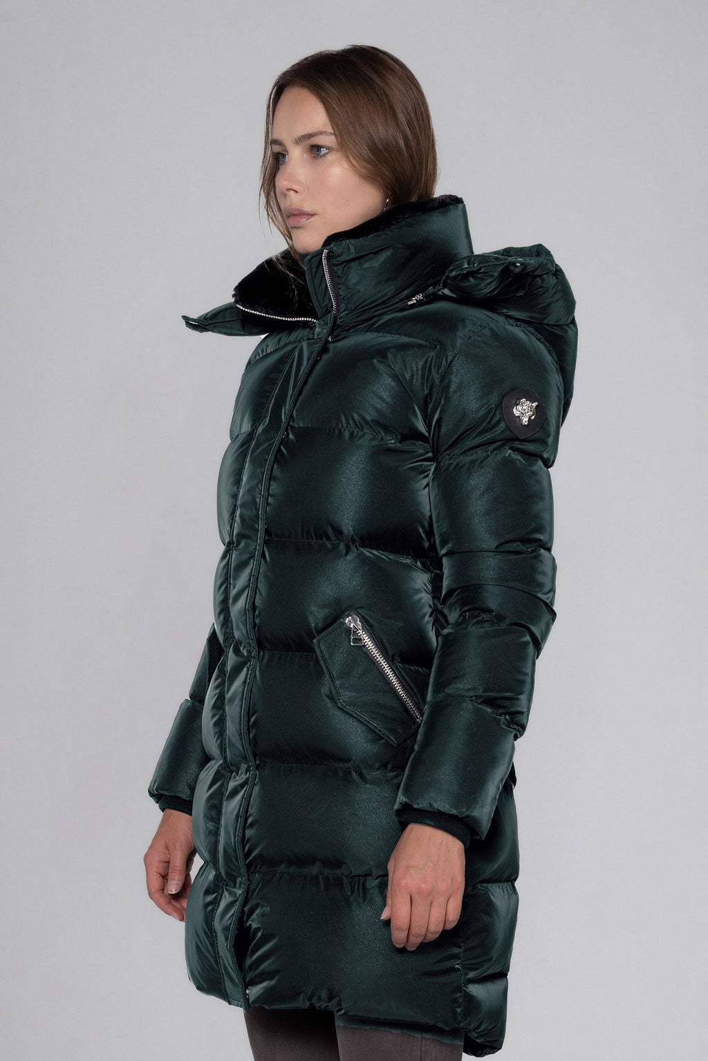 Woodpecker Women's Penguin Long Winter coat. High-end Canadian designer winter coat for women in "Green Diamond" colour. Woodpecker cruelty-free winter coat designed in Canada. Women's heavy weight long length premium designer jacket for winter. Superior quality warm winter coat for women. Moose Knuckles, Canada Goose, Mackage, Montcler, Will Poho, Willbird, Nic Bayley. Extra warm. Shiny parka. Stylish winter jacket. Designer winter coat.