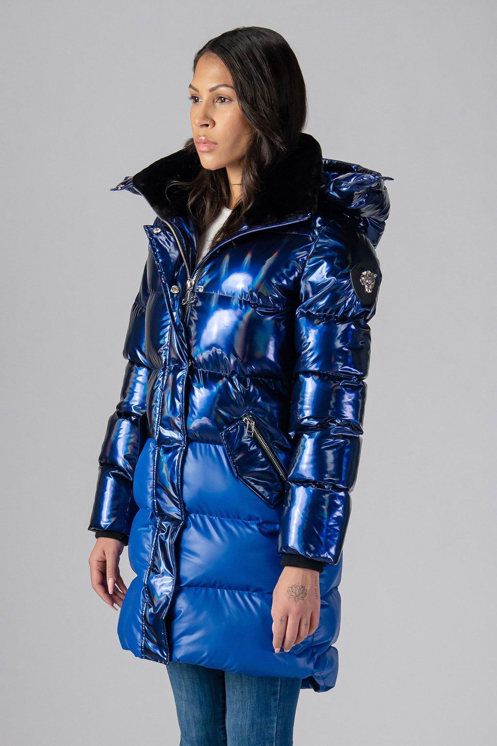 Woodpecker Women's Penguin Long Winter coat. High-end Canadian designer winter coat for women in "Oily Blue Blue" colour. Woodpecker cruelty-free winter coat designed in Canada. Women's heavy weight long length premium designer jacket for winter. Superior quality warm winter coat for women. Moose Knuckles, Canada Goose, Mackage, Montcler, Will Poho, Willbird, Nic Bayley. Extra warm. Shiny parka. Stylish winter jacket. Designer winter coat.