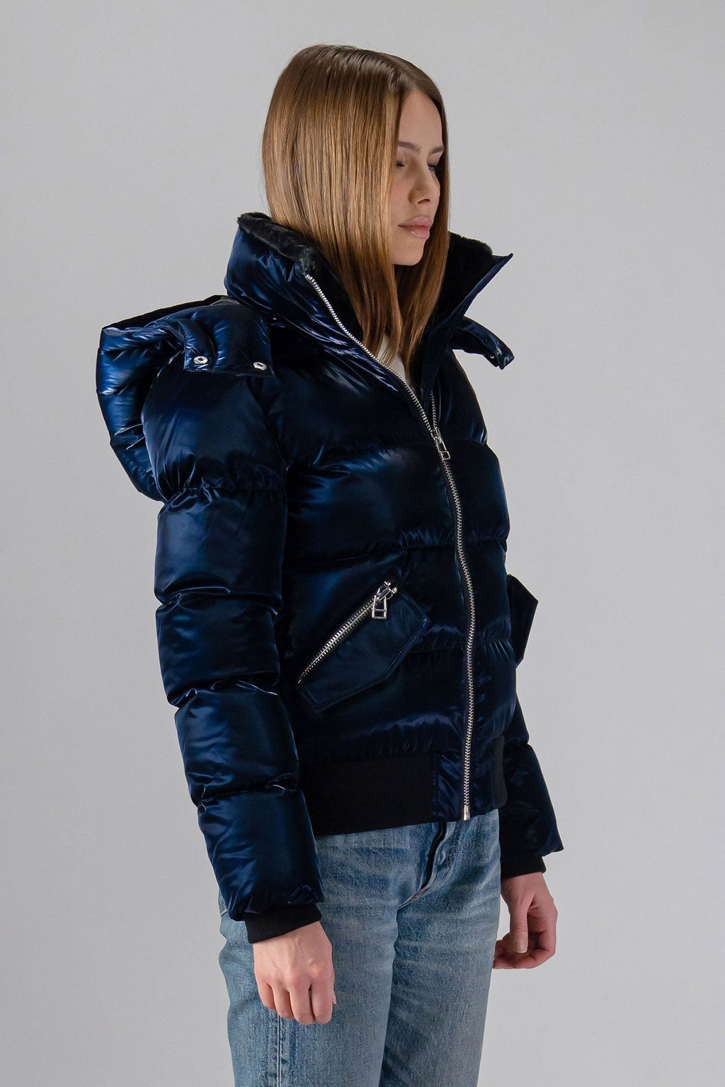 Woodpecker Women's Woody Bomber Winter coat. High-end Canadian designer winter coat for women in shiny “All Wet Navy". Woodpecker cruelty-free winter coat designed in Canada. Women's heavy weight short length premium designer jacket for winter. Superior quality warm winter coat for women. Moose Knuckles, Canada Goose, Mackage, Montcler, Will Poho, Willbird, Nic Bayley. Shiny parka. Stylish winter jacket. Designer winter coat.
