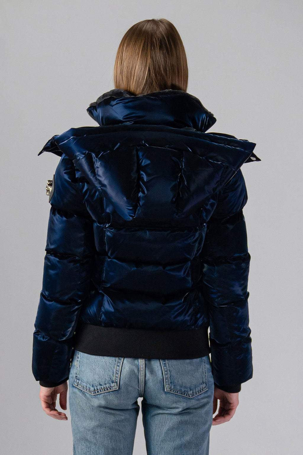 Woodpecker Women's Woody Bomber Winter coat. High-end Canadian designer winter coat for women in shiny “All Wet Navy". Woodpecker cruelty-free winter coat designed in Canada. Women's heavy weight short length premium designer jacket for winter. Superior quality warm winter coat for women. Moose Knuckles, Canada Goose, Mackage, Montcler, Will Poho, Willbird, Nic Bayley. Shiny parka. Stylish winter jacket. Designer winter coat.
