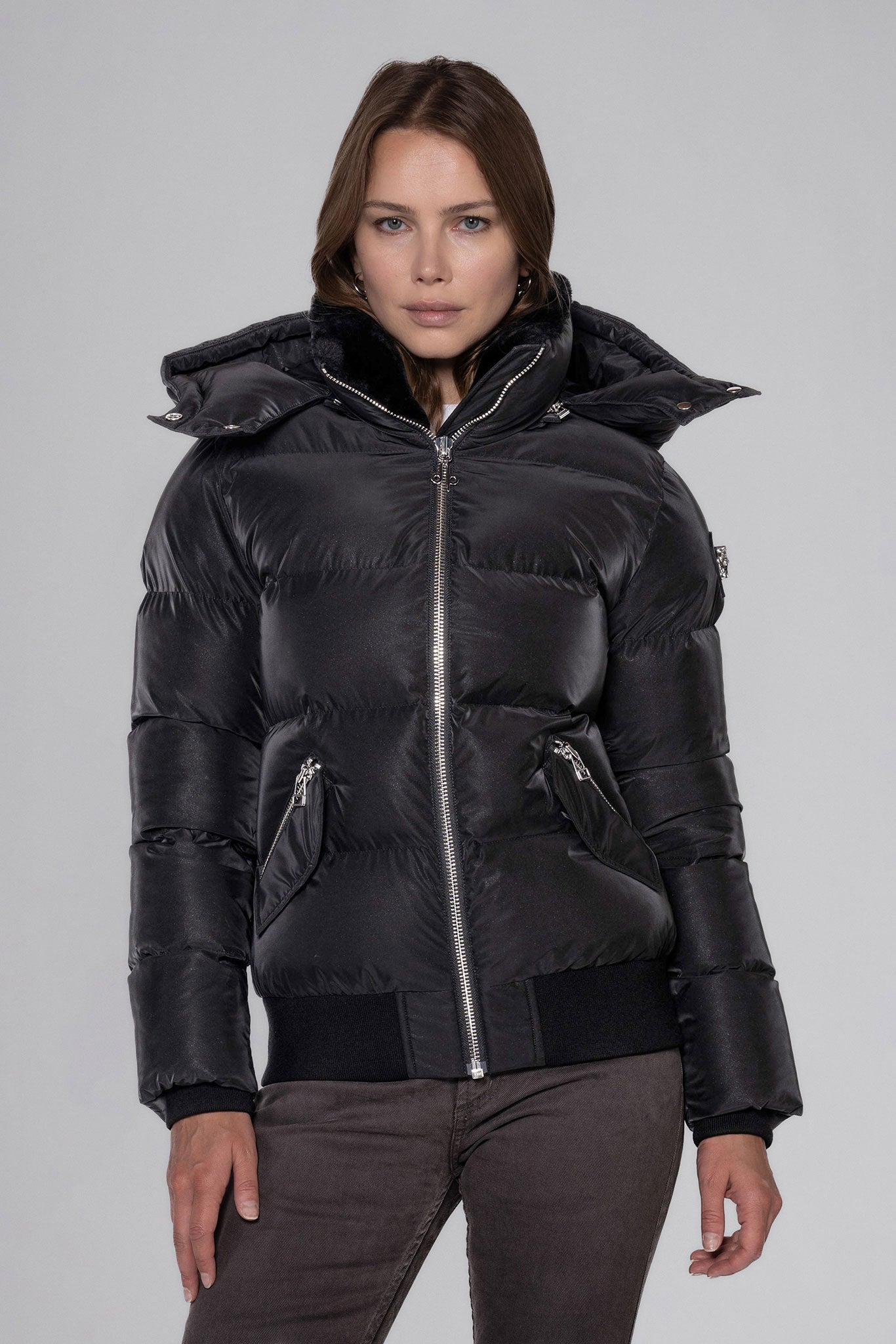 Woodpecker Women's Woody Bomber Winter coat. High-end Canadian designer winter coat for women in "Black Diamond" colour. Woodpecker cruelty-free winter coat designed in Canada. Women's heavy weight short length premium designer jacket for winter. Superior quality warm winter coat for women. Moose Knuckles, Canada Goose, Mackage, Montcler, Will Poho, Willbird, Nic Bayley. Shiny parka. Stylish winter jacket. Designer winter coat.