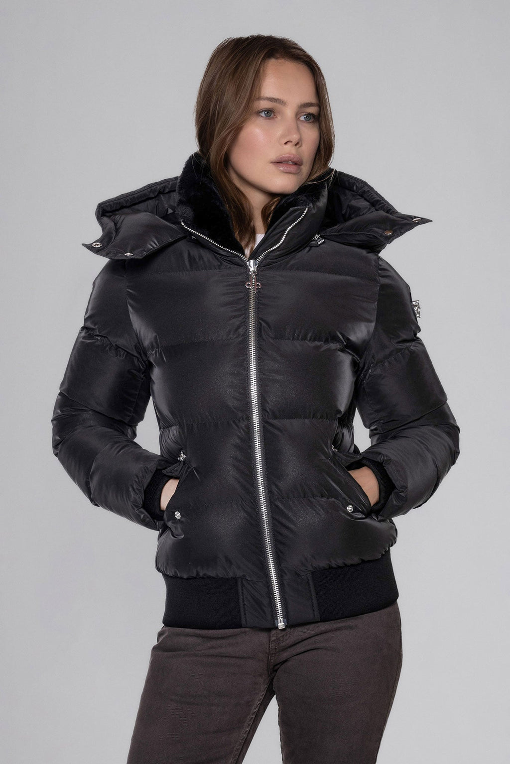 Woodpecker Women's Woody Bomber Winter coat. High-end Canadian designer winter coat for women in "Black Diamond" colour. Woodpecker cruelty-free winter coat designed in Canada. Women's heavy weight short length premium designer jacket for winter. Superior quality warm winter coat for women. Moose Knuckles, Canada Goose, Mackage, Montcler, Will Poho, Willbird, Nic Bayley. Shiny parka. Stylish winter jacket. Designer winter coat.