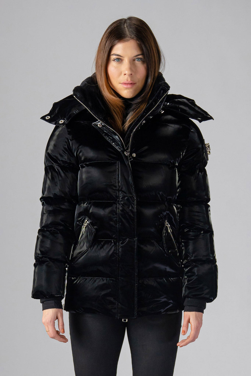 Woodpecker Women's Bumnester Winter coat. High-end Canadian designer winter coat for women in shiny "All Wet Black" colour. Woodpecker cruelty-free winter coat designed in Canada. Women's heavy weight medium length premium designer jacket for winter. Superior quality warm winter coat for women. Moose Knuckles, Canada Goose, Mackage, Montcler, Will Poho, Willbird, Nic Bayley. Extra warm. Shiny parka. Stylish winter jacket. Designer winter coat.